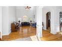 Spacious living room with hardwood floors, tall ceilings, large windows, and neutral color palette at 135 Antoinette Ave, Mcdonough, GA 30252