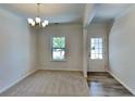 Bright dining space with carpet, chandelier, and easy access to the outside, ideal for entertaining at 156 Crescent Wooode Dr, Dallas, GA 30157