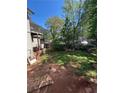 The backyard of the home with a balcony and wooden fencing on a bright, sunny day at 2245 Panstone Sw Dr, Marietta, GA 30060