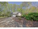 This lovely home showcases an attached garage, driveway, and lush landscaping, blending comfort and curb appeal at 115 Beechwood Trl, Roswell, GA 30075