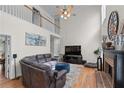 Bright living room with hardwood floors, fireplace, soaring ceilings, and oversized windows for natural light at 1270 Cameron Crk, Marietta, GA 30062
