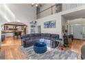 Open-concept living room featuring hardwood floors, soaring ceilings, fireplace, and seamless transition to the kitchen at 1270 Cameron Crk, Marietta, GA 30062