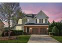 Charming two-story home featuring a brick facade, attached two-car garage, landscaped front yard, and a welcoming entrance at 3465 Caney Creek Ln, Cumming, GA 30041