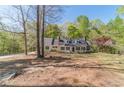 A quaint home with well maintained landscaping and a partial stone wall, nestled among mature trees at 3775 Belle Glade Trl, Snellville, GA 30039