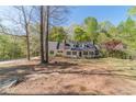 Inviting home with a classic design, complemented by a sprawling front yard and mature trees at 3775 Belle Glade Trl, Snellville, GA 30039