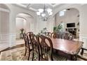 Spacious dining area boasts hardwood floors, decorative rug, and decorative chairs, filled with natural light at 609 Eskimo Ct, Cts, Hampton, GA 30228