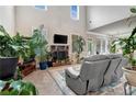 Bright living room featuring vaulted ceiling, fireplace, and comfortable seating ideal for relaxation at 609 Eskimo Ct, Cts, Hampton, GA 30228
