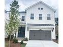 Charming two-story home with a gray attached garage, manicured lawn, and green front door at 683 Summitt Hill Way, Cumming, GA 30040