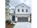 Two-story home with white exterior, gray garage door, and well-maintained lawn at 683 Summitt Hill Way, Cumming, GA 30040