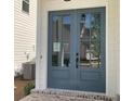 Elegant double front doors with glass panels, adding a touch of sophistication to the home's entrance at 683 Summitt Hill Way, Cumming, GA 30040