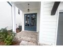 Stylish blue double front doors with brick steps and white pillars at 683 Summitt Hill Way, Cumming, GA 30040