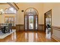 Grand foyer boasting hardwood floors, high ceilings, and an arched doorway at 755 Peninsula Overlook, Hampton, GA 30228