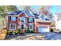 Stately two-story brick home with a manicured lawn and attached two car garage at 1081 Talon Trce, Lawrenceville, GA 30043