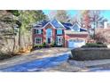 Charming two-story brick home with a well-maintained lawn and two car garage at 1081 Talon Trce, Lawrenceville, GA 30043