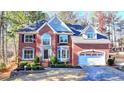 Charming two-story brick home featuring an attached garage and professionally landscaped front yard at 1081 Talon Trce, Lawrenceville, GA 30043