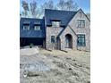 New two-story brick home with dormers and attached garage at 2461 Fernleaf Nw Ct, Atlanta, GA 30318