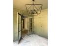 Home office featuring a modern light fixture and French doors at 2461 Fernleaf Nw Ct, Atlanta, GA 30318
