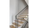 Modern staircase with wooden steps and black iron railing at 2461 Fernleaf Nw Ct, Atlanta, GA 30318
