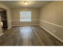 Dining room featuring hardwood floors, neutral paint, and a large window for ample natural light at 3472 Riverview Chase Way, Ellenwood, GA 30294