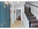 Inviting foyer featuring tile flooring, staircase with wooden treads, and views of other rooms at 706 Twin Brooks Se Ct, Marietta, GA 30067