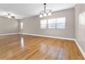 Spacious living room featuring gorgeous hardwood floors, and three large windows at 2230 Cheshire Bridge Rd # 412, Atlanta, GA 30324