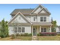 Charming two-story home with light siding, well-manicured landscaping, and welcoming front entrance at 245 Fender Walk, Marietta, GA 30060