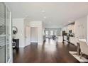 Open-concept living space featuring gleaming hardwood floors, lots of natural light, and modern finishes at 245 Fender Walk, Marietta, GA 30060