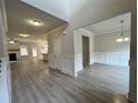 Open-concept living room and dining room with hardwood floors and neutral paint at 80 Hawthorn Ln, Covington, GA 30014
