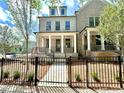 Beautiful light brick two story home features a welcoming front porch and black wrought iron fencing at 1059 Dryden Ln # 11, Atlanta, GA 30319