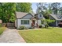 Charming bungalow home featuring a well-manicured lawn and inviting front porch at 1535 Deerwood Dr, Decatur, GA 30030