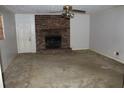 Living room with carpet and a classic brick fireplace, ready for cozy evenings at 1646 Hurt Sw Rd, Marietta, GA 30008