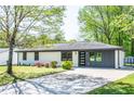 Well-manicured front yard with a charming single-story home and extended driveway at 3719 Paul St, Douglasville, GA 30135