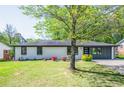 Inviting home featuring a lush green lawn and mature trees in a serene setting at 3719 Paul St, Douglasville, GA 30135