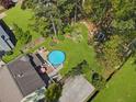 Stunning aerial view showcasing a pool, sprawling yard, and mature trees, creating a private oasis at 5539 Hurstcliffe Nw Dr, Kennesaw, GA 30152