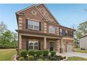 Attractive brick home with a covered porch, black shutters, and a well-maintained front yard at 811 Holly Mist Ct, Loganville, GA 30052