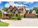 Spacious home featuring brick and stone facade, three-car garage and a beautiful driveway at 2740 Drayton Hall Dr, Buford, GA 30519