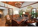 Beautiful office space boasts wood-beamed ceilings, a grand desk, and an inviting fireplace at 2740 Drayton Hall Dr, Buford, GA 30519