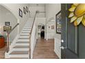 Bright foyer with hardwood floors, staircase, and view into the living spaces at 602 Redbud Ter, Canton, GA 30115