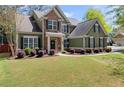 Inviting home exterior showcasing manicured lawn, shrubbery, and neutral paint at 602 Redbud Ter, Canton, GA 30115