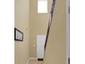 Light-filled hallway with staircase, light wood floors, neutral walls, and white trim throughout the entrance at 6884 Robinson St, Lithonia, GA 30058