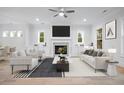 Bright living room with fireplace, built-in cabinets, and contemporary furniture arrangement at 1010 Coleman Place Dr, Roswell, GA 30075