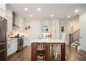 Modern kitchen with stainless steel appliances, white cabinets, and a spacious island with bar seating at 204 Phillips Ln, Alpharetta, GA 30009