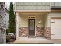 Inviting front porch with stone accents and decorations near the home's entrance at 540 Broughton Dr, Canton, GA 30114