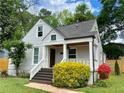 Inviting front porch with stained wood stairs and columns surrounded by colorful landscaping at 2010 Bixby Se St, Atlanta, GA 30317