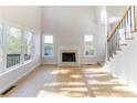 Bright living room with a fireplace, large windows, and elegant hardwood floors at 288 Pine Way, Dallas, GA 30157