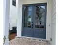 Elegant home entrance with stylish double doors and a brick-paved porch at 685 Summitt Hill Way, Cumming, GA 30040