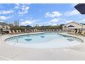 Beautiful outdoor community pool with plenty of seating and umbrellas to relax and enjoy the sunshine at 1000 Sutherland Lane (Lot 35), Lawrenceville, GA 30043
