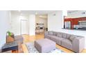 Open-concept living room with stylish seating, hardwood floors, and seamless flow to kitchen at 200 Renaissance Ne Pkwy # 219, Atlanta, GA 30308