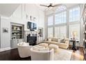 Bright, elegant living room with soaring ceilings, built-in shelves, fireplace, and large windows with natural light at 2032 Grovewood Ct, Cumming, GA 30041