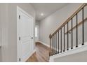 Inviting entryway with hardwood floors and staircase with decorative rod iron railings at 2413 Malster Ln, Lawrenceville, GA 30043